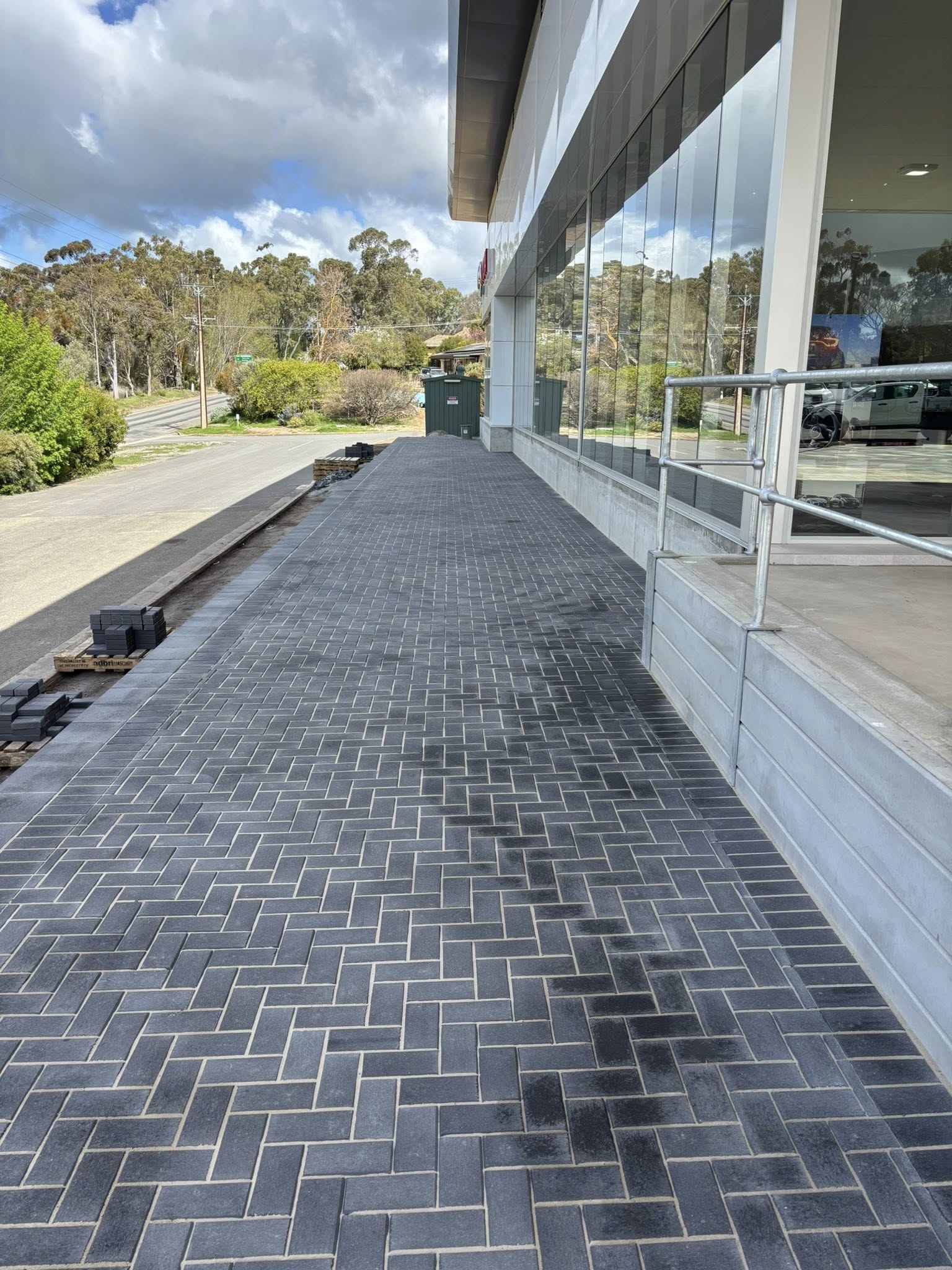 Commercial herringbone brick paving — shopfront path installation