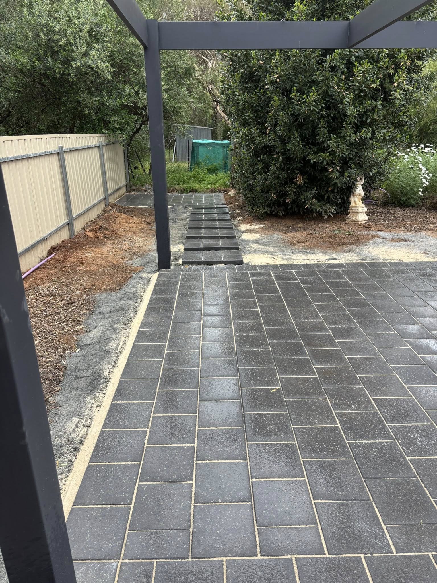 Dark slate paving under pergola — outdoor entertaining area with timber deck