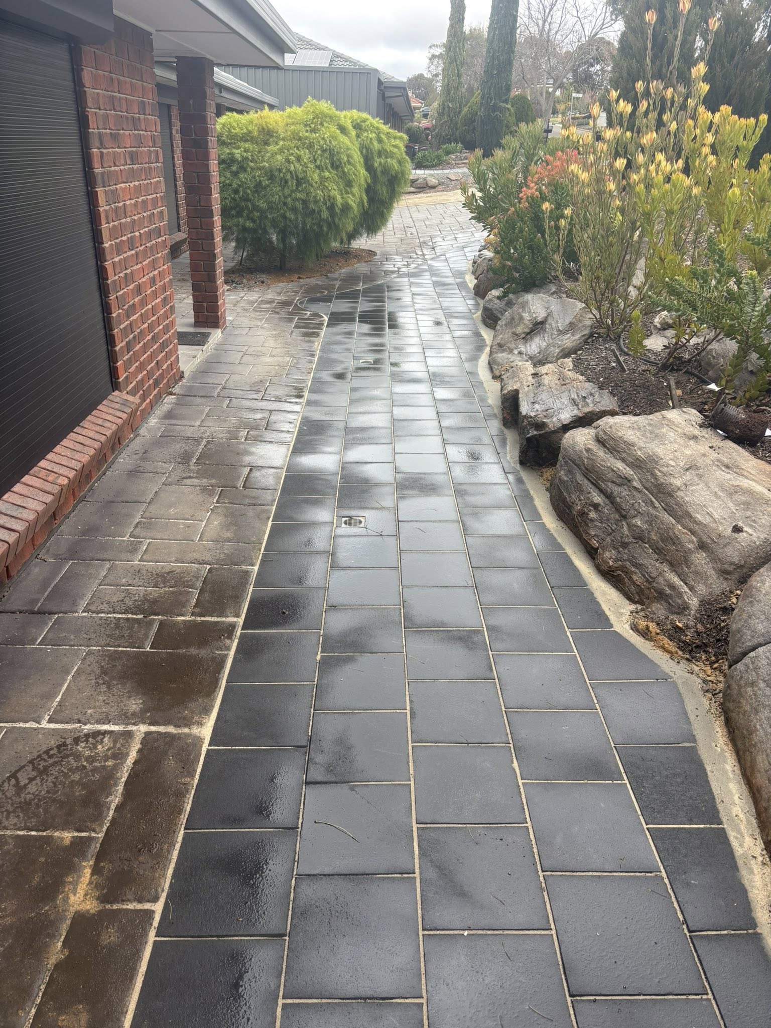 Dark slate curved pathway with composite steps — outdoor paving