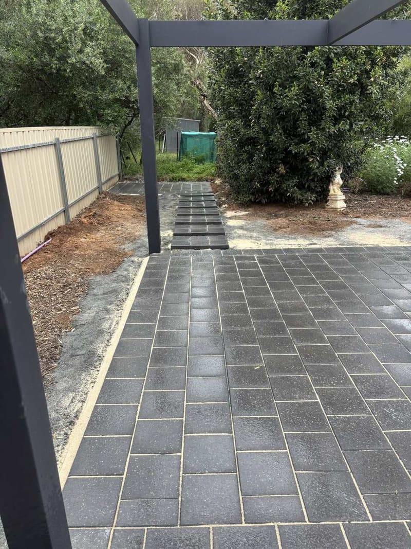 Dark slate paving under pergola — outdoor entertaining area with timber deck